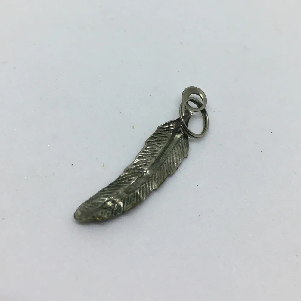 Feather shaped silver tone pendant charm